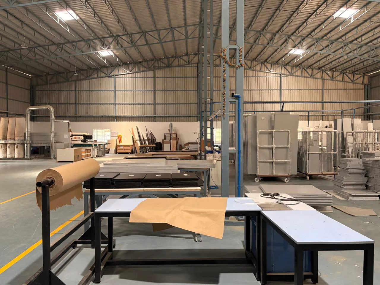 Panel stacks and packing stations on the Elvenwood factory floor in Bommasandra
