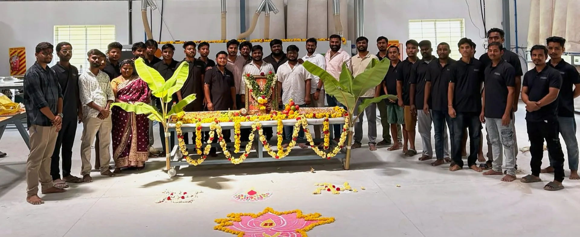 The full Elvenwood Interiors team gathered at a pooja on the factory floor in Bommasandra