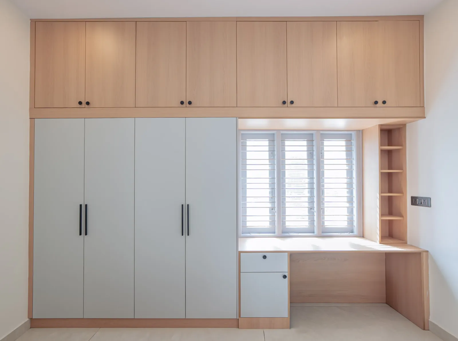 Built-in hinged wardrobe with loft storage and a study desk — full view