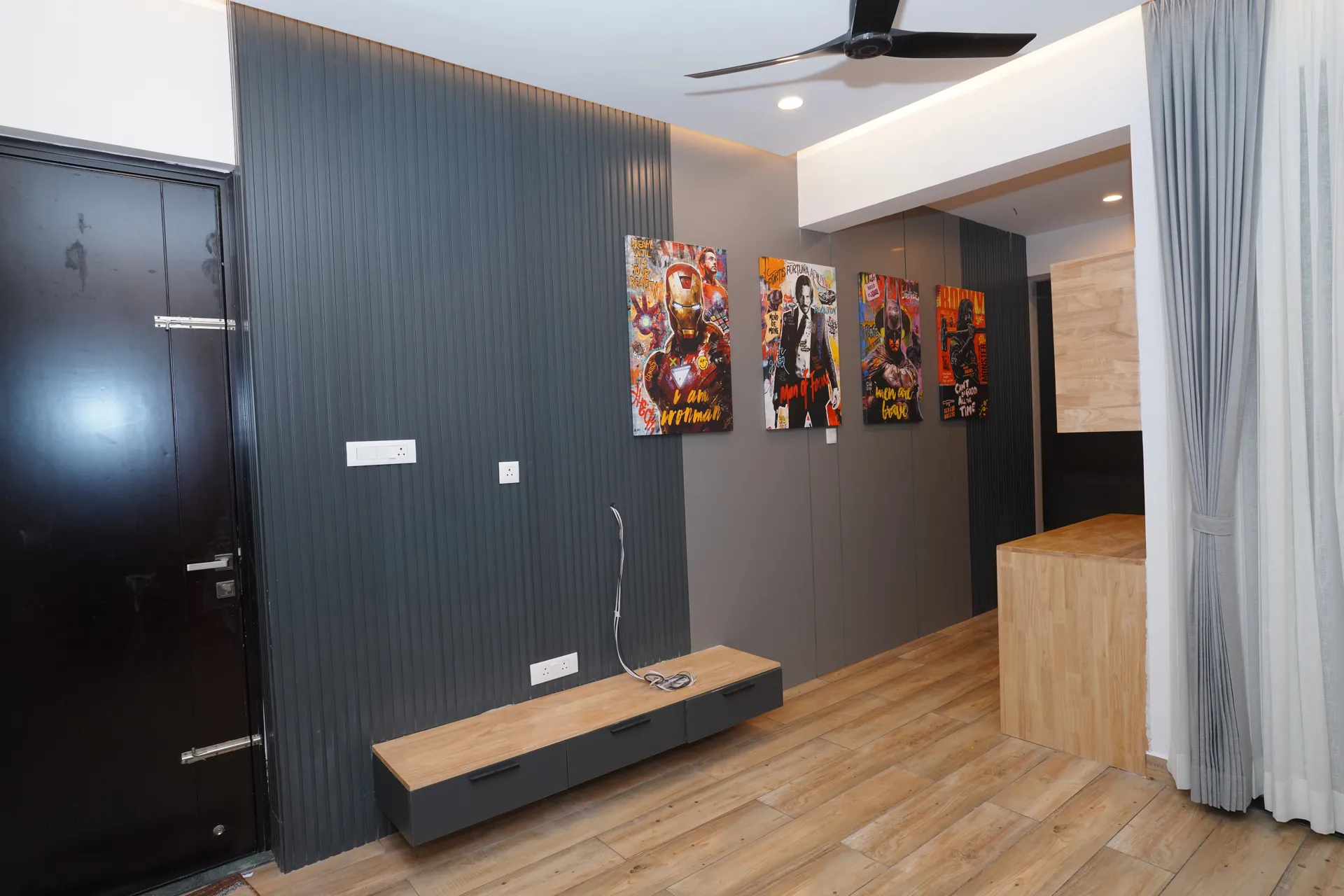 Living room TV wall with charcoal fluted panel and floating wooden console, villa at SVS Silver Oaks, Heelalige